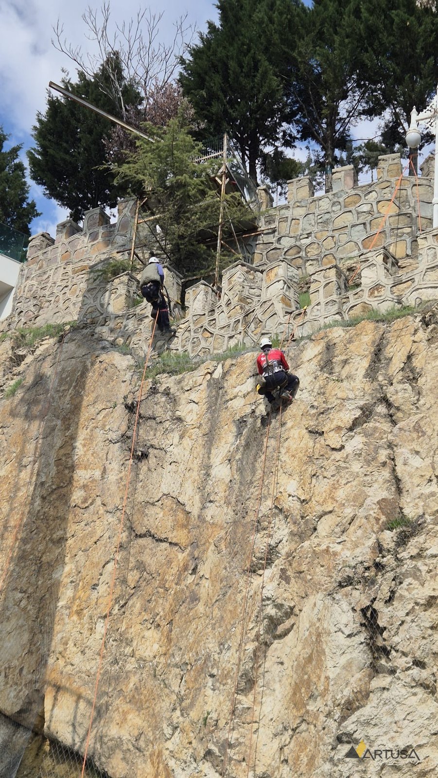 Rope-access scaling on a rock face